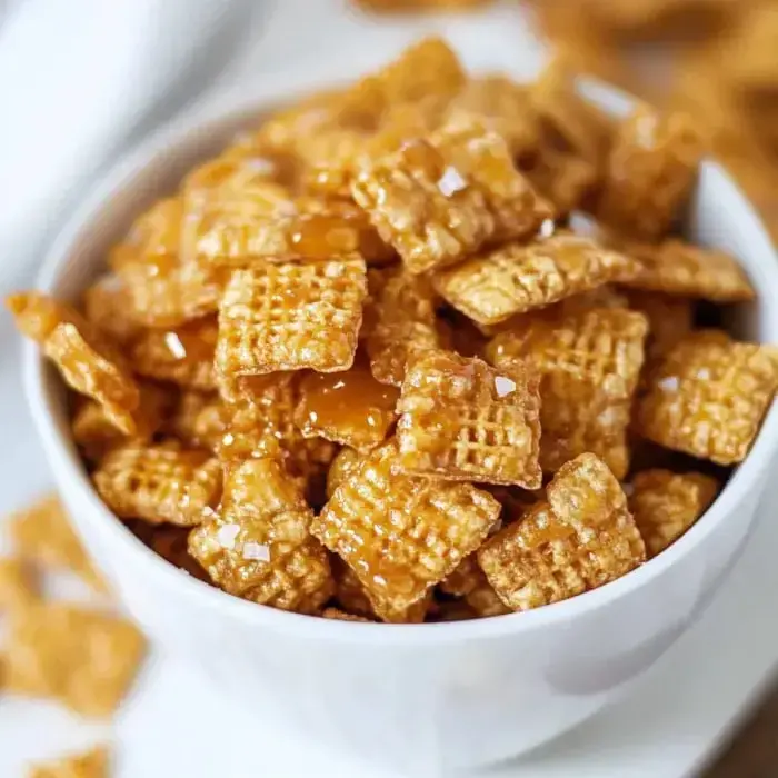 A bowl filled with caramel-glazed cereal bits sprinkled with a touch of sea salt.