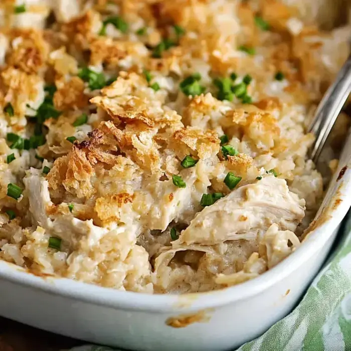 Creamy chicken bake, crispy crumbs on top, fresh green onions scattered over.