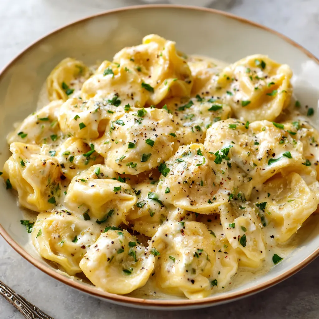 A bowl of pasta with cheese and herbs.
