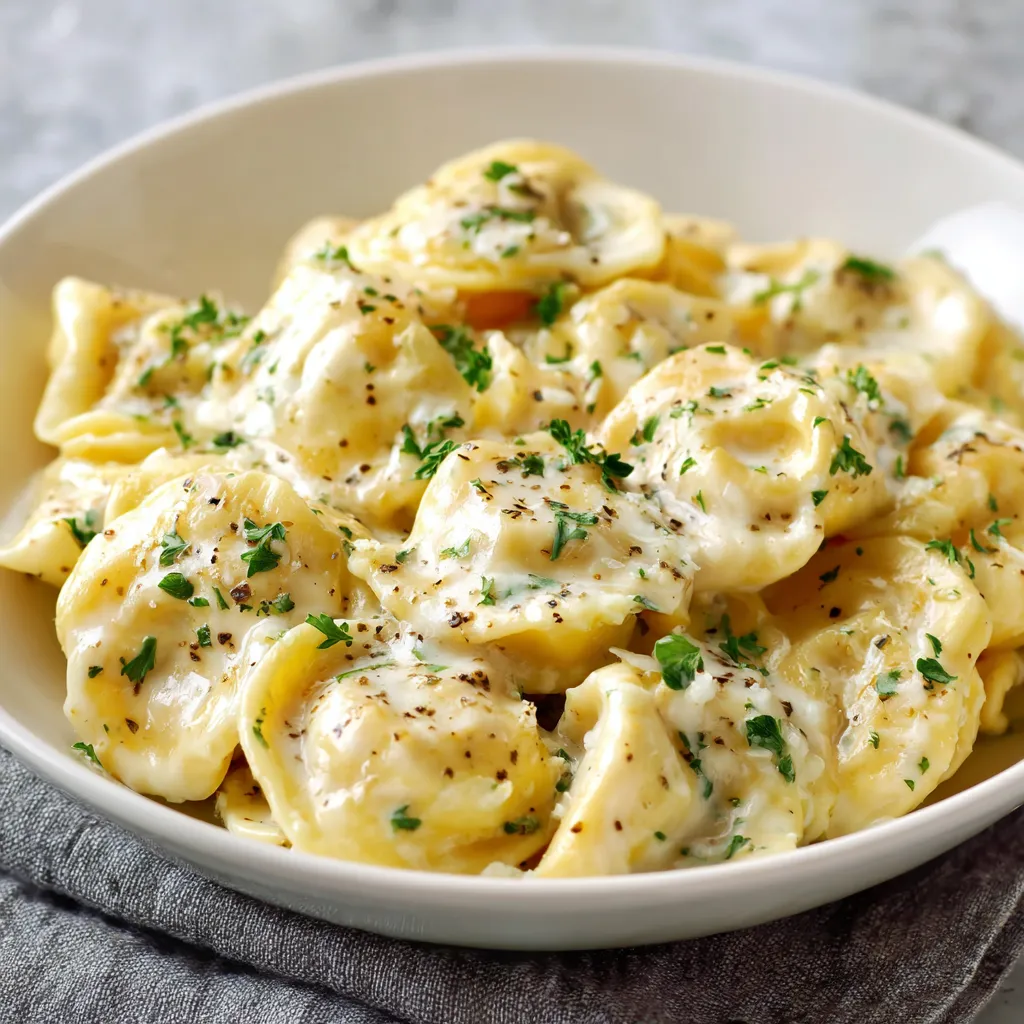 A bowl of pasta with cheese and herbs.