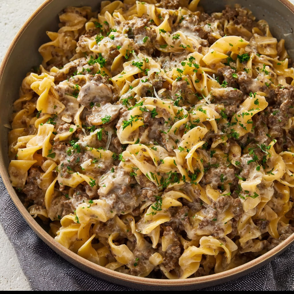 A bowl of pasta with meat and cheese.